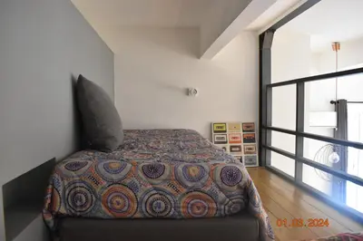 a bedroom with a bed and a large window at Trastevere St Ariabianca House in Rome