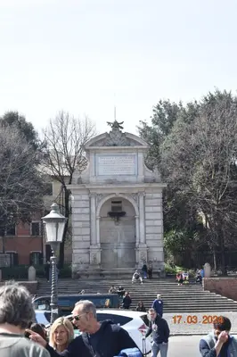 a group of people standing in front of a monument at Trastevere St Ariabianca House in Rome