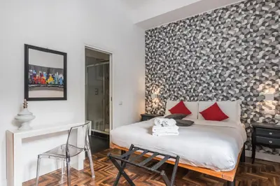 a bedroom with a white bed and red pillows at New Prati Luxury Apartment in Rome