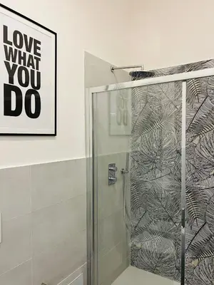 a shower with a glass door in a bathroom at New Prati Luxury Apartment in Rome