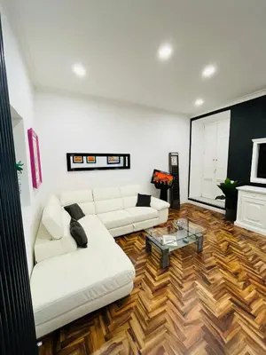 a living room with a white couch and a coffee table at New Prati Luxury Apartment in Rome