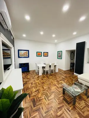 a living room with a table and chairs at New Prati Luxury Apartment in Rome