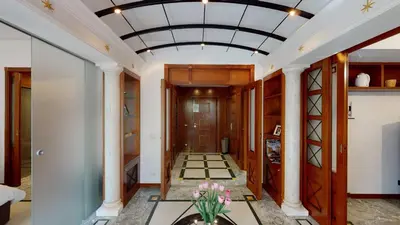 a hallway with a coffered ceiling with a vase of flowers at Pietra Papa Suite 99 in Rome