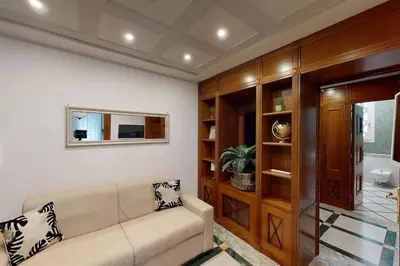 a living room with a couch and a mirror at Pietra Papa Suite 99 in Rome