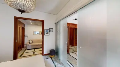 a living room with a couch and a chandelier at Pietra Papa Suite 99 in Rome