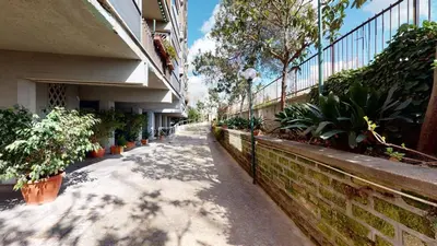 a walkway with potted plants on the side of a building at Pietra Papa Suite 99 in Rome