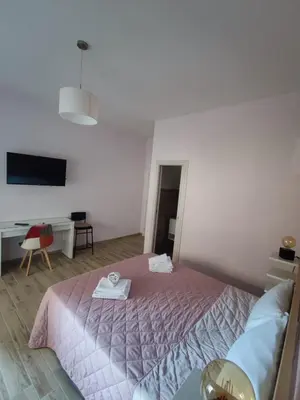 a bedroom with a bed and a table and a tv at Style House 74 in Rome