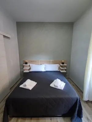 a bedroom with a bed with two towels on it at Style House 74 in Rome