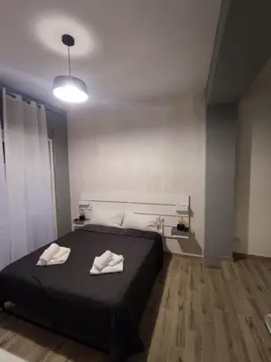 a bedroom with a bed with two towels on it at Style House 74 in Rome