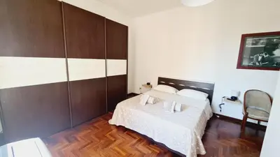 a bedroom with a bed and a wooden floor at Trastevere Rome's Heart Charming & Cozy appartment 3 in Rome