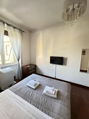 a bedroom with a bed with two towels on it at Trastevere Rome's Heart Charming & Cozy appartment 3 in Rome