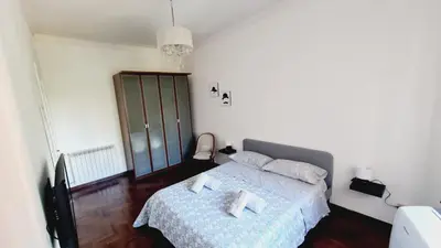 a bedroom with a bed with a blue comforter at Trastevere Rome's Heart Charming & Cozy appartment 3 in Rome
