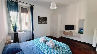 a bedroom with a blue bed and a television at Trastevere Rome's Heart Charming & Cozy appartment 3 in Rome
