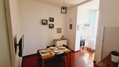 a dining room with a table and a refrigerator at Trastevere Rome's Heart Charming & Cozy appartment 3 in Rome