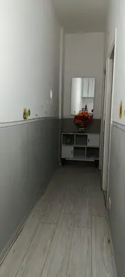 an empty kitchen with a refrigerator and a wooden floor at Sunflower House in Rome
