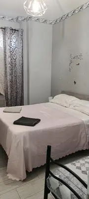 a bedroom with a bed and a chair in it at Sunflower House in Rome