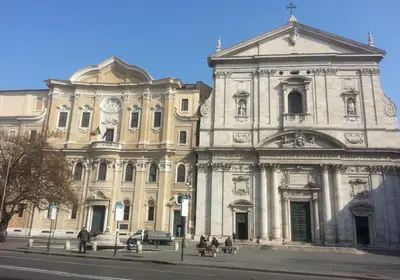 a large building with people sitting in front of it at Warm Charming Apartment in Campo de Fiori in Rome