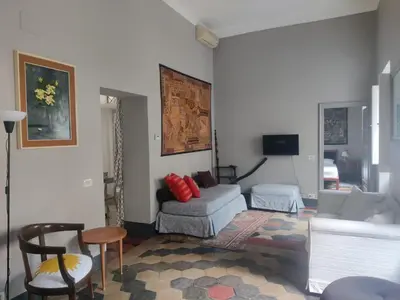 a living room with a couch and a chair at Warm Charming Apartment in Campo de Fiori in Rome