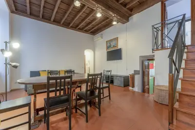 a dining room with a table and chairs at Ciambella Arch Apartment for 6 people @Largo Argentina in Rome