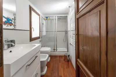 a bathroom with a sink and a toilet and a shower at Ciambella Arch Apartment for 6 people @Largo Argentina in Rome