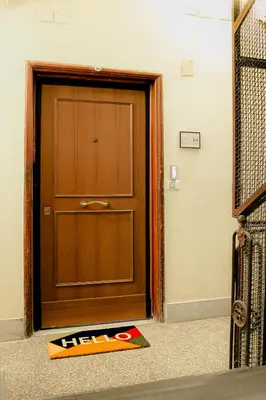 a door with ahiba sign on the floor in front of it at Lele Rooms Termini in Rome