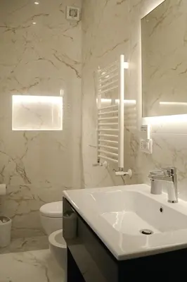 a white bathroom with a sink and a toilet at Lele Rooms Termini in Rome