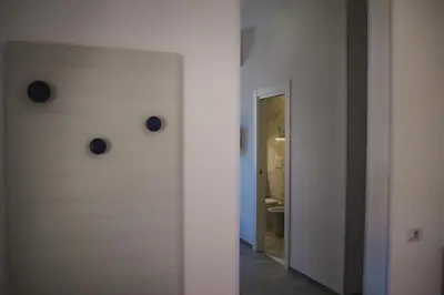 a white room with a door with two buttons on it at Lele Rooms Termini in Rome
