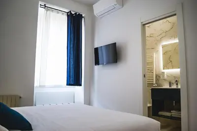 a bedroom with a bed and a window and a sink at Lele Rooms Termini in Rome