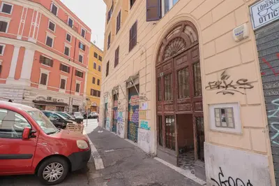 a red car parked on a city street with buildings at [Roma Termini] - Suite elegante in Rome