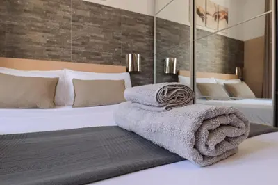 a bedroom with a large bed and a bath tub at [Roma Termini] - Suite elegante in Rome