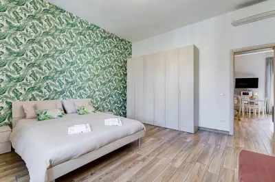 a bedroom with a bed and a green wall at My Sweet R-home in Vatican in Rome