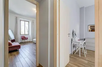 a hallway with a room with a chair and a table at My Sweet R-home in Vatican in Rome