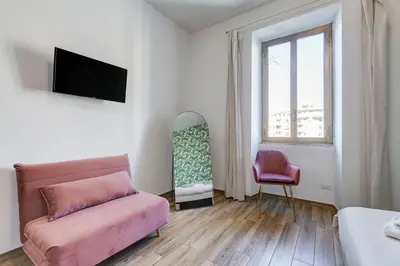 a living room with a couch and a window at My Sweet R-home in Vatican in Rome