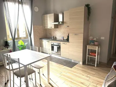 a kitchen with a table and chairs in a room at My Sweet R-home in Vatican in Rome