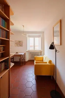 a living room with a yellow couch and a table at Quiet apartment in the heart of Trastevere in Rome