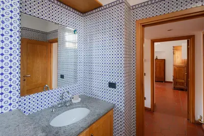 a bathroom with a sink and a mirror at Quiet apartment in the heart of Trastevere in Rome