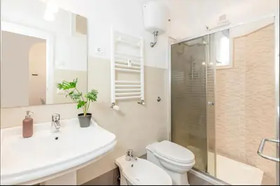 a bathroom with a toilet and a sink and a shower at Bell Appartamento in Rome