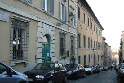 a row of cars parked on a street next to buildings at Nannì Vatican House in Rome