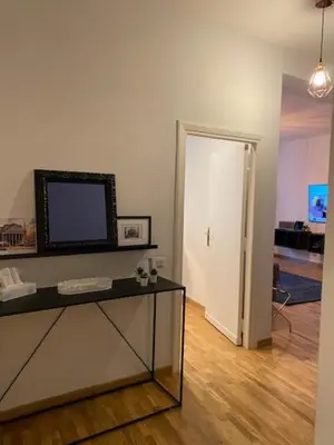 a living room with a television on a table and a door at Dimora Centro Storico Roma in Rome