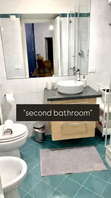 a bathroom with a sink and a toilet and a mirror at Dimora Centro Storico Roma in Rome
