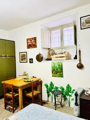 a room with a table and a dining room at La Casetta di San Giovanni 1924 in Rome