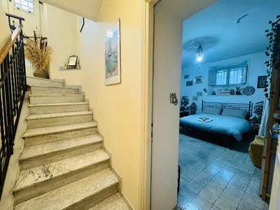 a stairway leading to a room with a bed at La Casetta di San Giovanni 1924 in Rome