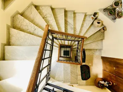 a room with a spiral staircase and a mirror at La Casetta di San Giovanni 1924 in Rome