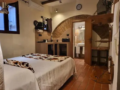 a bedroom with a bed and a bathroom with a sink at The Rabbit Hole in Rome