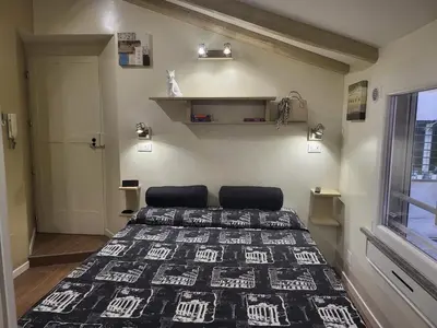 a bedroom with a bed with a black and white blanket at The Fox Cove in Rome