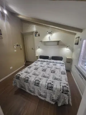 a bedroom with a bed with a comforter on it at The Fox Cove in Rome