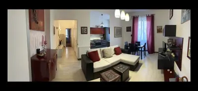a living room with a couch and a kitchen at TRADITIONAL ROME Stay in Rome