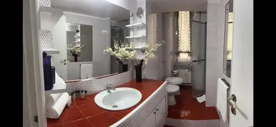 a white bathroom with a sink and a toilet at TRADITIONAL ROME Stay in Rome