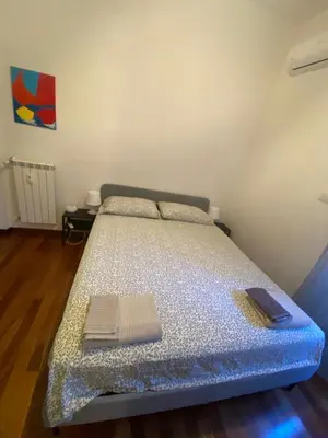 a bedroom with a bed with two books on it at Appio11 Apartment in Rome