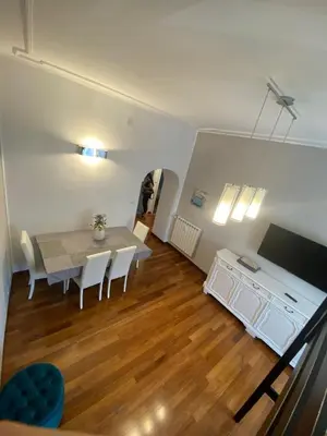 a dining room with a table and chairs and a television at Appio11 Apartment in Rome